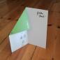 Mobile Preview: grüne Neujahrskarte zum Basteln eines Papierfliegers (mit gefalteter Ecke)